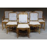 A set of eight French beech dining chairs, late 19th, early 20th Century with carved scrolling