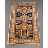 A Shirvan prayer rug with three medallions in deep blue field below an arch and signature strips and