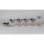 Stuart Devlin for Viners of Sheffield, four stainless steel cups, with gilt metal stems of