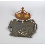 An Art Nouveau pewter dish, 20th century, moulded with a nude lady seated picking a flower, 22.5cm
