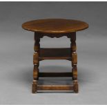 A Titchmarsh & Goodwin circular oak two tier side table, second half 20th Century, the turned legs