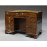 An Edwardian mahogany and line inlaid knee hole desk, with two frieze drawers, above knee hole