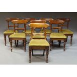 A set of eight Victorian bar back mahogany dining chairs, with green velvet drop in seats, on turned