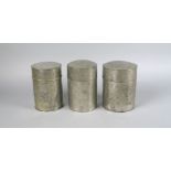 Three Chinese cylindrical pewter tea caddies, 20th century, each with lids, incised with Chinese
