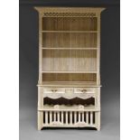 A contemporary limed pine dresser, second half 20th Century, the moulded cornice above three