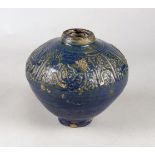 A dark blue pottery vase, Iran, 12-13th century, the shoulders moulded with a line of calligraphy,