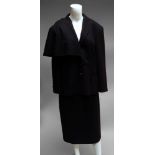 A Gucci black wool jacket and skirt suit, size 46, the jacket with half cape