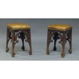 A pair of Victorian Gothic oak stools, with leather upholstered seats (2)
