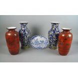 A pair of Chinese porcelain vases, late 20th century, decorated with prunus blossom on blue grounds,