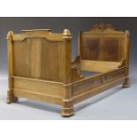 A Victorian walnut single bed, with foliate and scroll carved crest, the panelled sides and