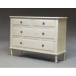 A white painted chest of drawers, of recent manufacture, the rectangular top over two short