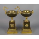 A pair of French gilt bronze urns, late 19th century, with pine apple form finials to the lids,