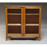 A Victorian mahogany freestanding bookcase with pair of mesh-set doors, raised on splayed feet,