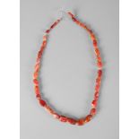 A Western Asiatic necklace of graduated carnelian and agate faceted beads, circa 1000 BC, 47cm.