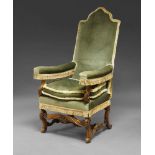 A 17th Century style French walnut armchair, 20th Century, upolstered in green velvet, with one