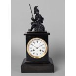 A French ebonised wood and marble mantel clock, 19th century, the metal finial in the form of a