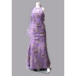 Jacques Azagury: a lilac shot silk and lilac net evening gown, with silk applique flowers, the