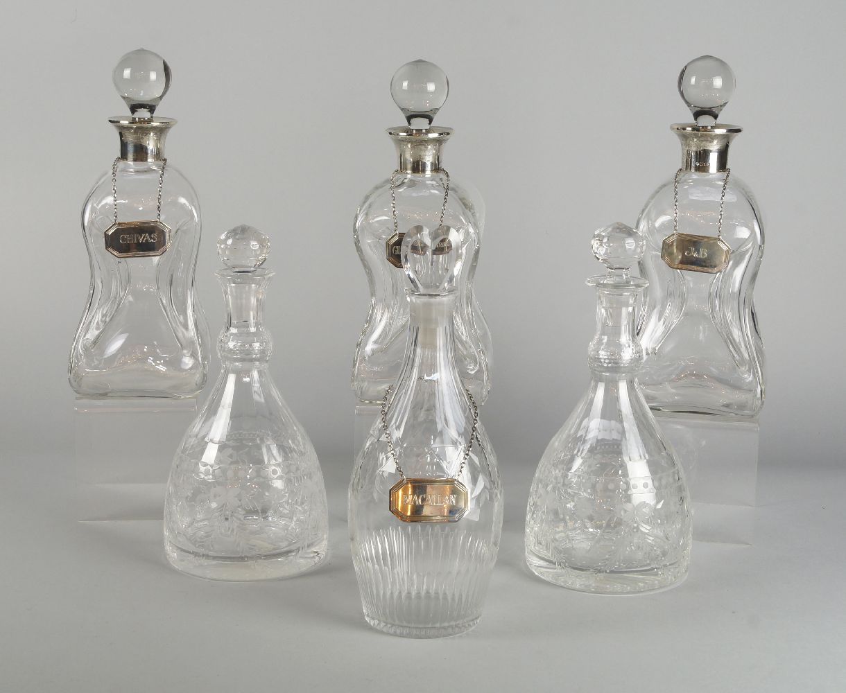 A Georgian glass decanter, the stopper with a heart shaped finial, with cut decoration, 28cm high,