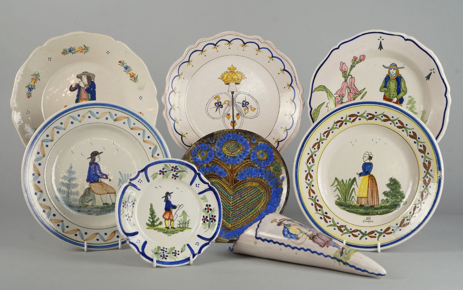 A pair of Quimper pottery plates by Henriot, 20th century, decorated to the centres with male and