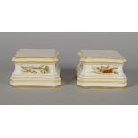 A pair of KPM porcelain pedestals, late 19th/early 20th century, of shaped architectural form,