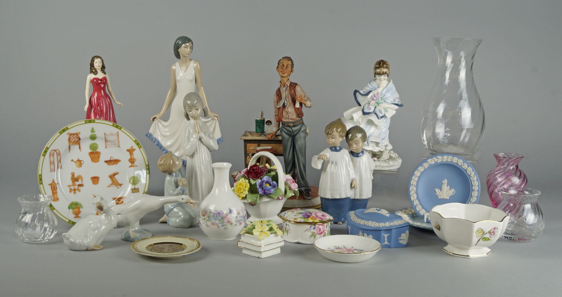 A Nao figure of a girl in a white dress. 20th century, together with two groups of Nao and Lladro