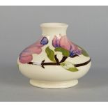 Magnolias on white ground, a Moorcroft squat vase, signed to base, 11cm high