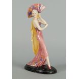 A Katzhutte porcelain figure of a girl. 20th century, modelled in a pink gown holding a pink fan, on