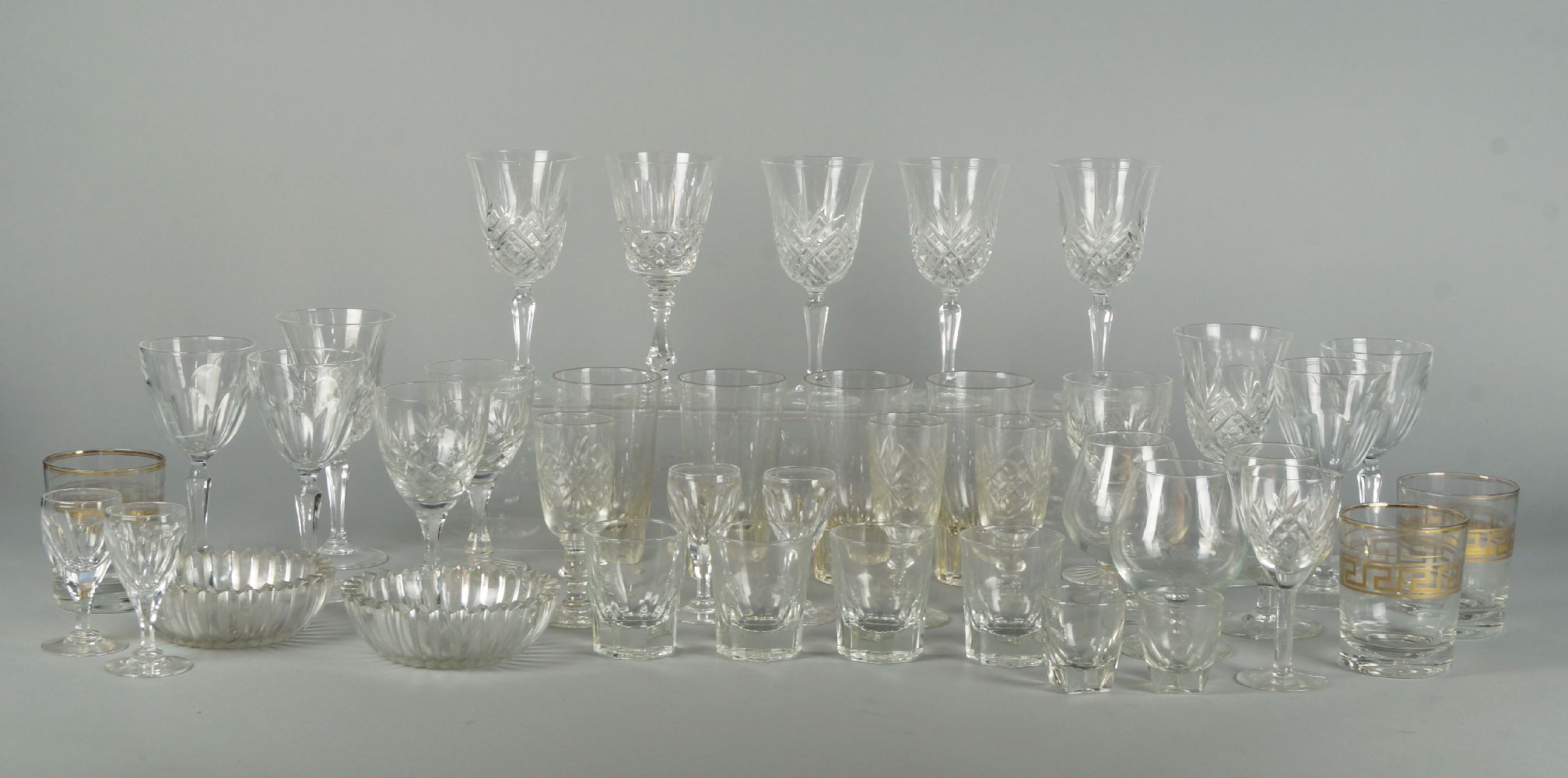 A set of six tulip form drinking glasses. 20th century, 16.5cm high, together with a quantity of