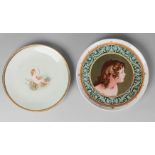 A Victorian painted plate by J M Camm, decorated with a figure of a girl, within a green scrolling