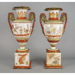 A pair of Continental painted and gilt twin handled vases, late 19th century, resting on square