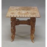 A carved Burmese side table, the square top carved with kneeling figures, animals and foliate