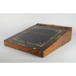 A Victorian burr walnut and brass bound writing slope, opening to reveal a gilt tooled leather