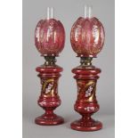 A pair of cranberry tinted glass oil lamps, possibly made for the Turkish Market, early 20th