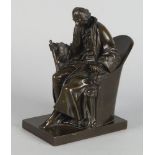 A French bronze model of a seated man, 19th century, modelled holding a long scroll, seated in a