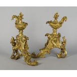 A pair of French gilt bronze chenets, 19th century, modelled in the Rococo taste, with griffin