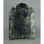 An Italian glass easel mirror, 20th century, of shaped outline with foliate engraved edge, 55 x 40.