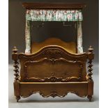 A Victorian and later walnut double half tester bed, the curved half canopy with curtains, the