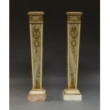 A pair of faux marble pedestals, 20th Century, of tapering form, with pink marble tops, decorated