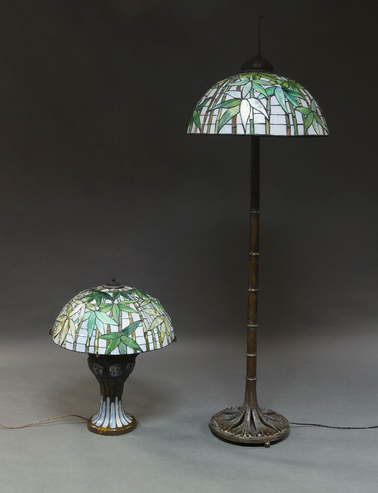 A Tiffany style standard lamp, of recent manufacture, the coloured glass and leaded shade with