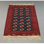 A Turkman rug with three rows of guls in a green field 172cm x 124cm and a tekke rug with four panel