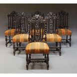 A set of six Jacobean style carved oak dining chairs, early 20th Century, the backrests with