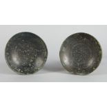 A pair of Middle Eastern bronze shallow dishes, decorate to the interior centres with geometric