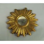 A giltwood sun burst mirror, with convex mirror glass, 24cm diameter (VAT charged on hammer price)