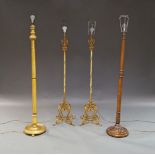 A pair of gilt wrought metal standard lamps, 20th Century, with spiral columns and applied scrolling