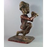 An Indian carved wood and painted figure of a man, possibly a piper, 19th/20th century, modelled