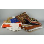 An African spread, 20th century, woven in geometric striped designs, in white, black and orange,