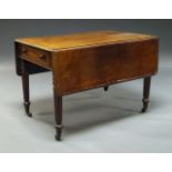 A Victorian mahogany Pembroke table, with opposing frieze drawers, on turned and reeded legs to