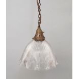 A brass and glass light fitting, early 20th century, the shade of domed petal form with holophane