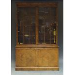 George III style walnut bookcase, early 20th Century, the moulded cornice over two astragal glazed