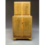 An Art Deco burr walnut cocktail cabinet, The top with two doors enclosing mirrored interior with